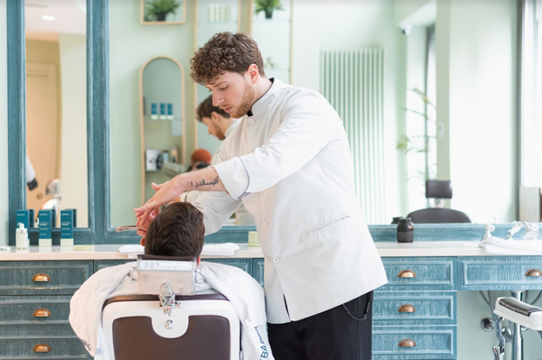 Barbiere fa la barba in un barbershop a Milano